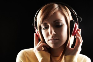 Woman Wearing Headphones A girl is listening to a background music