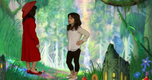 A girl in a red dress is talking to another girl