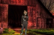 Girl is standing next to a barn, singing